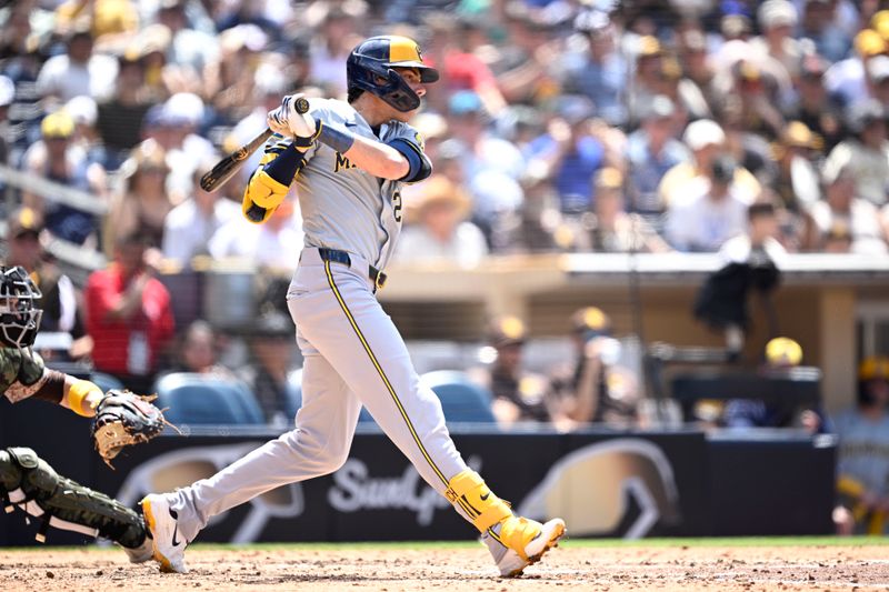 Jun 23, 2024; San Diego, California, USA; Milwaukee Brewers designated hitter Christian Yelich (22) hits a single against the San Diego Padres during the seventh inning at Petco Park. Mandatory Credit: Orlando Ramirez-USA TODAY Sports