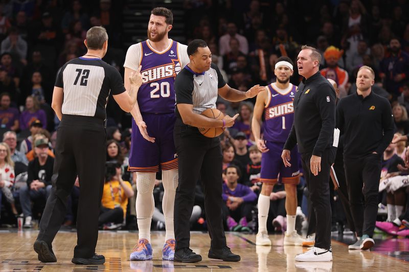 PHOENIX, ARIZONA - FEBRUARY 14:  Head coach Frank Vogel and Jusuf Nurkic #20 of the Phoenix Suns react to referees J.T. Orr #72 and Karl Lane #77 after Devin Booker #1 was ejected for a double technical foul during the first half of the NBA game at Footprint Center on February 14, 2024 in Phoenix, Arizona. NOTE TO USER: User expressly acknowledges and agrees that, by downloading and or using this photograph, User is consenting to the terms and conditions of the Getty Images License Agreement.  (Photo by Christian Petersen/Getty Images)