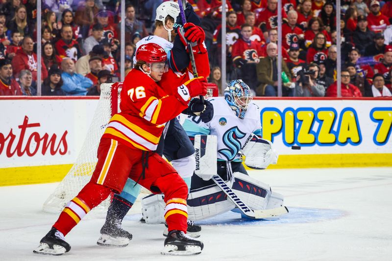 Dec 27, 2023; Calgary, Alberta, CAN; Seattle Kraken goaltender Chris Driedger (60) makes a save against the Calgary Flames during the second period at Scotiabank Saddledome. Mandatory Credit: Sergei Belski-USA TODAY Sports