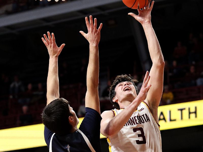Dec 29, 2025; Minneapolis, Minnesota, USA; Minnesota Golden Gophers forward Bobby Durkin (3) shoots as Fairleigh Dickinson Knights guard David Jevtic (35) defends during the first half at Williams Arena. Mandatory Credit: Matt Krohn-Imagn Images