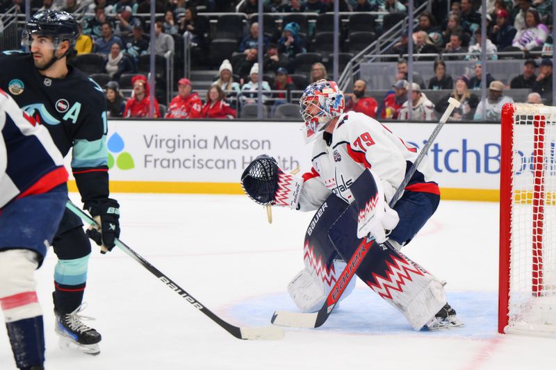 Jan 23, 2025; Seattle, Washington, USA; Washington Capitals goaltender Charlie Lindgren (79) defends the goal against the Seattle Kraken during the first period at Climate Pledge Arena. Mandatory Credit: Steven Bisig-Imagn Images