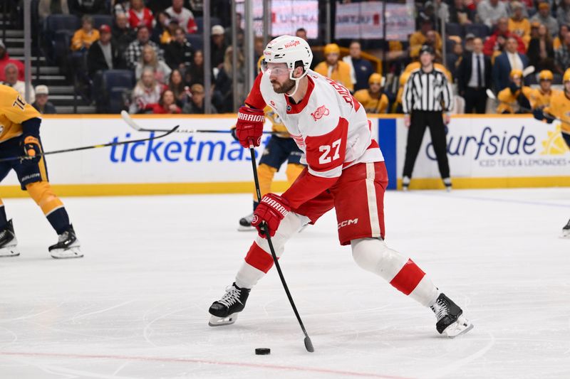 Mar 2, 2026; Nashville, Tennessee, USA;  Detroit Red Wings center Michael Rasmussen (27) takes a shot on goal against the Nashville Predators during the first period at Bridgestone Arena. Mandatory Credit: Steve Roberts-Imagn Images