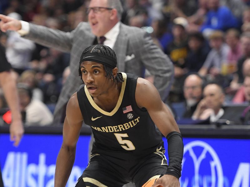 Mar 11, 2023; Nashville, TN, USA;  Vanderbilt Commodores guard Ezra Manjon (5) dribbles against the Texas A&M during the first half at Bridgestone Arena. Mandatory Credit: Steve Roberts-USA TODAY Sports