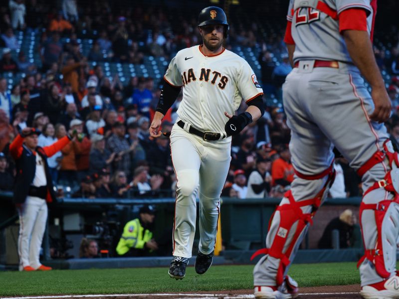 Aug 28, 2023; San Francisco, California, USA; San Francisco Giants center fielder Austin Slater (13) scores a run behind Cincinnati Reds catcher Luke Maile (22) during the first inning at Oracle Park. Mandatory Credit: Kelley L Cox-USA TODAY Sports