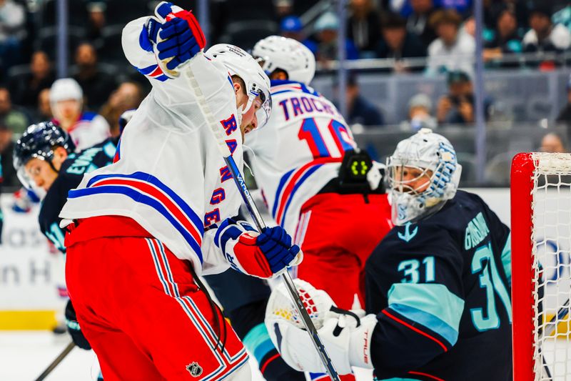 Nov 17, 2024; Seattle, Washington, USA; New York Rangers left wing Alexis Lafrenière (13, left) scores a goal against Seattle Kraken goaltender Philipp Grubauer (31) during the second period at Climate Pledge Arena. Mandatory Credit: Joe Nicholson-Imagn Images