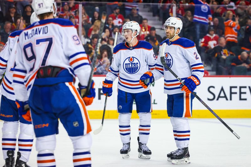 Apr 6, 2024; Calgary, Alberta, CAN; Edmonton Oilers defenseman Evan Bouchard (2) celebrates his goal with teammates against the Calgary Flames during the third period at Scotiabank Saddledome. Mandatory Credit: Sergei Belski-USA TODAY Sports