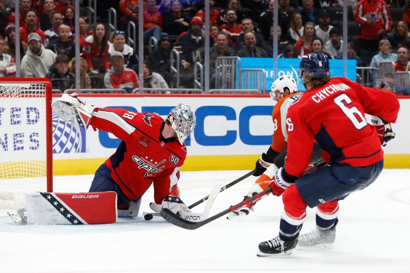 Oct 23, 2024; Washington, District of Columbia, USA; Washington Capitals goaltender Logan Thompson (48) makes a save on Philadelphia Flyers center Morgan Frost (48) as Capitals defenseman Jakob Chychrun (6) chases in the second period at Capital One Arena. Mandatory Credit: Geoff Burke-Imagn Images