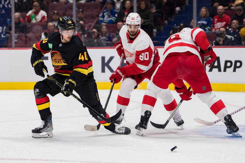 Feb 13, 2023; Vancouver, British Columbia, CAN; Vancouver Canucks forward Elias Pettersson (40) battles with Detroit Red Wings forward Joe Veleno (90) and defenseman Ben Chiarot (8) in the first period at Rogers Arena. Mandatory Credit: Bob Frid-USA TODAY Sports