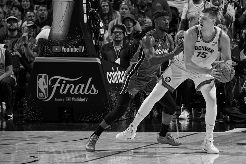 DENVER, CO - JUNE 12: (EDITORS NOTE: this photo has been converted to black and white) Jimmy Butler #22 of the Miami Heat plays defense on Nikola Jokic #15 of the Denver Nuggets during Game Five of the 2023 NBA Finals on June 12, 2023 at Ball Arena in Denver, Colorado. NOTE TO USER: User expressly acknowledges and agrees that, by downloading and or using this Photograph, user is consenting to the terms and conditions of the Getty Images License Agreement. Mandatory Copyright Notice: Copyright 2023 NBAE (Photo by Garrett Ellwood/NBAE via Getty Images)