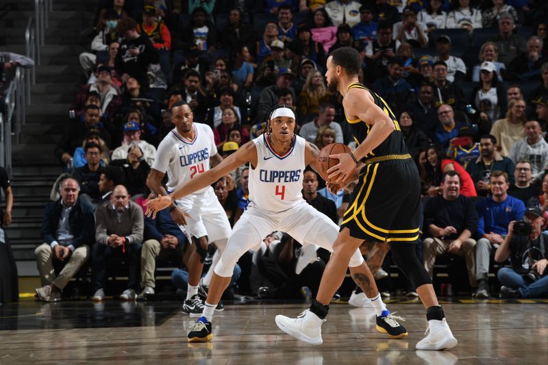 SAN FRANCISCO, CA - FEBRUARY 14: Brandon Boston Jr. #4 of the LA Clippers plays defense against the Golden State Warriors on FEBRUARY 14, 2024 at Chase Center in San Francisco, California. NOTE TO USER: User expressly acknowledges and agrees that, by downloading and or using this photograph, user is consenting to the terms and conditions of Getty Images License Agreement. Mandatory Copyright Notice: Copyright 2024 NBAE (Photo by Noah Graham/NBAE via Getty Images)