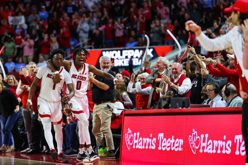 Feb 19, 2023; Raleigh, North Carolina, USA;  North Carolina State Wolfpack guard Jarkel Joiner (1) and guard Terquavion Smith (0) celebrate during the second half of the game against North Carolina Tar Heels at PNC Arena. Mandatory Credit: Jaylynn Nash-USA TODAY Sports