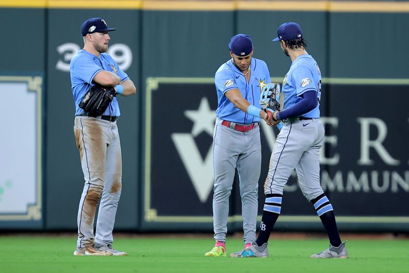 Jul 30, 2023; Houston, Texas, USA; The Tampa Bay Rays outfielders congratulate each other after the final out against the Houston Astros during the ninth inning at Minute Maid Park. Mandatory Credit: Erik Williams-USA TODAY Sports