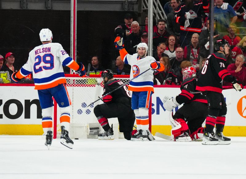 Apr 22, 2024; Raleigh, North Carolina, USA; New York Islanders center Kyle Palmieri (21) scores a goal past Carolina Hurricanes goaltender Frederik Andersen (31) during the first period in game two of the first round of the 2024 Stanley Cup Playoffs at PNC Arena. Mandatory Credit: James Guillory-USA TODAY Sports