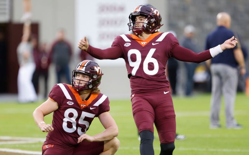 Oct 9, 2021; Blacksburg, Virginia, USA;  Virginia Tech Hokies place kicker John Parker Romo (96) makes a field goal from the hold of Virginia Tech Hokies punter Peter Moore (85) before the game against the Notre Dame Fighting Irish at Lane Stadium. Mandatory Credit: Reinhold Matay-USA TODAY Sports