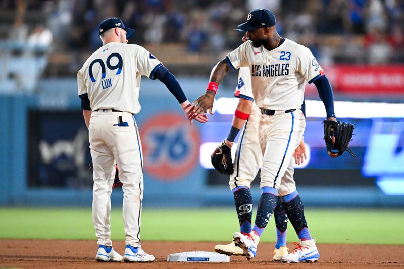 Jun 22, 2024; Los Angeles, California, USA; Los Angeles Dodgers outfielder Jason Heyward (23) and second baseman Gavin Lux (9) celebrate after defeating the Los Angeles Angels during the ninth inning at Dodger Stadium. Mandatory Credit: Jonathan Hui-USA TODAY Sports