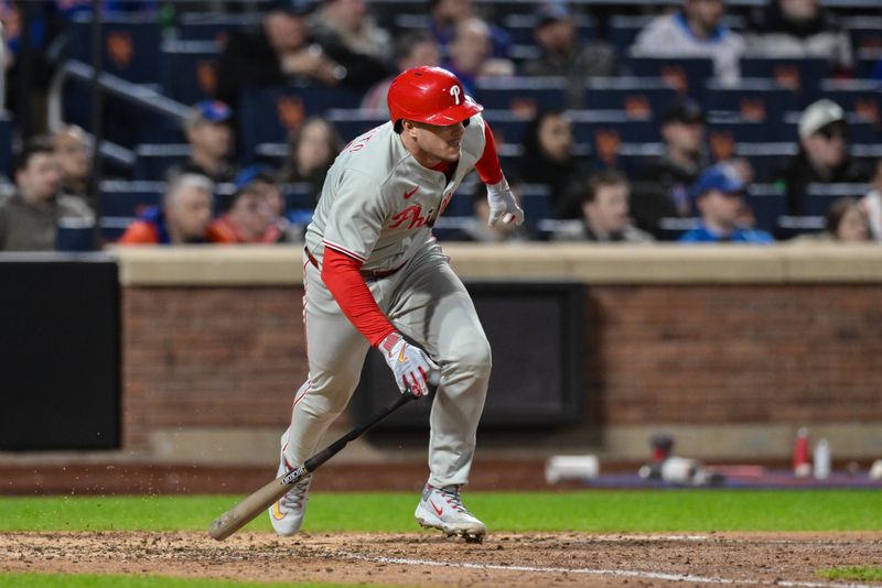 Apr 21, 2025; New York City, New York, USA; Philadelphia Phillies catcher J.T. Realmuto (10) hits a RBI single against the New York Mets during the ninth inning at Citi Field. Mandatory Credit: John Jones-Imagn Images