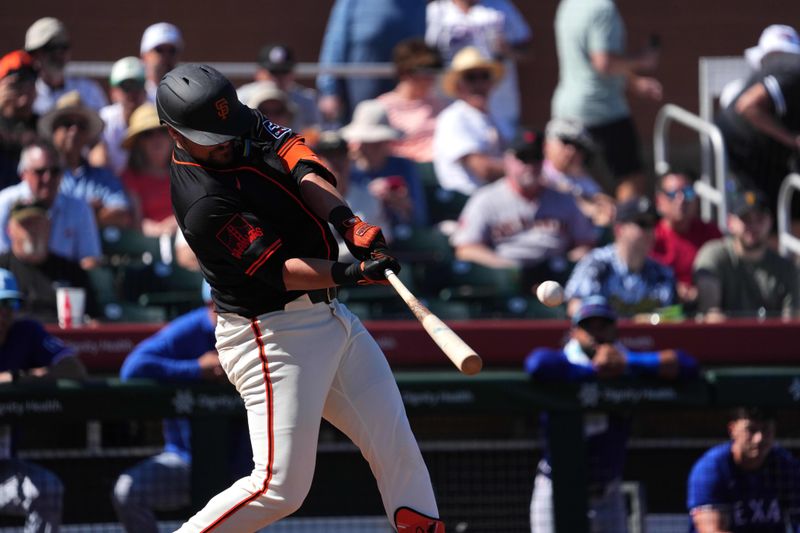 Mar 1, 2024; Scottsdale, Arizona, USA; San Francisco Giants first baseman J.D. Davis (7) hits a home run against the Texas Rangers during the second inning at Scottsdale Stadium. Mandatory Credit: Joe Camporeale-USA TODAY Sports