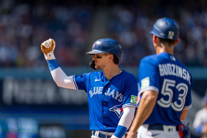 Aug 13, 2023; Toronto, Ontario, CAN; Toronto Blue Jays second baseman Cavan Biggio (8) celebrates after hitting a single against the Chicago Cubs during the sixth inning at Rogers Centre. Mandatory Credit: Kevin Sousa-USA TODAY Sports