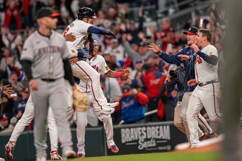 Apr 5, 2024; Cumberland, Georgia, USA; Atlanta Braves catcher Travis d'Arnaud (16) reacts with teammates after driving in the game winning run with a hit against Arizona Diamondbacks relief pitcher Scott McGough (30) during the tenth inning at Truist Park. Mandatory Credit: Dale Zanine-USA TODAY Sports