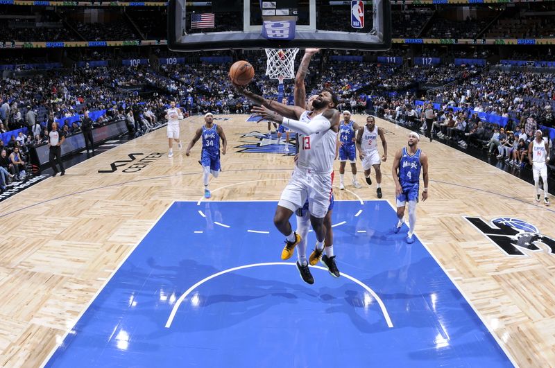 ORLANDO, FL - MARCH 29: Paul George #13 of the LA Clippers drives to the basket during the game against the Orlando Magic on March 29, 2024 at the Kia Center in Orlando, Florida. NOTE TO USER: User expressly acknowledges and agrees that, by downloading and or using this photograph, User is consenting to the terms and conditions of the Getty Images License Agreement. Mandatory Copyright Notice: Copyright 2024 NBAE (Photo by Fernando Medina/NBAE via Getty Images)