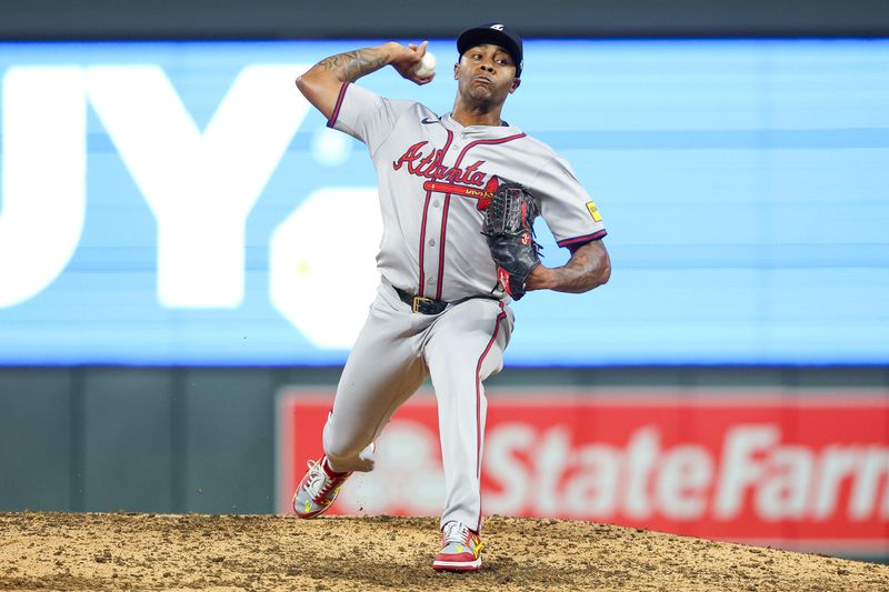 Aug 28, 2024; Minneapolis, Minnesota, USA; Atlanta Braves relief pitcher Raisel Iglesias (26) delivers a pitch against Minnesota Twins during the ninth inning at Target Field. Mandatory Credit: Matt Krohn-USA TODAY Sports