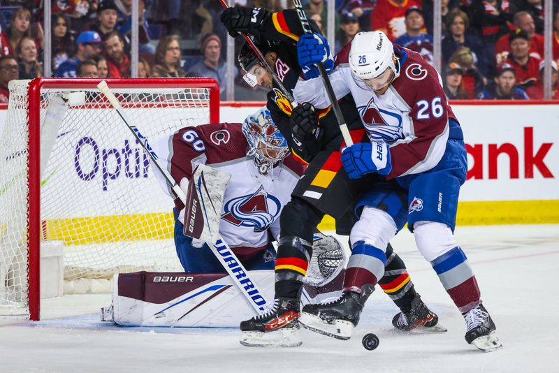 Mar 12, 2024; Calgary, Alberta, CAN; Colorado Avalanche defenseman Sean Walker (26) and Calgary Flames center Nazem Kadri (91) battles for the puck in front of Colorado Avalanche goaltender Justus Annunen (60) during the second period at Scotiabank Saddledome. Mandatory Credit: Sergei Belski-USA TODAY Sports