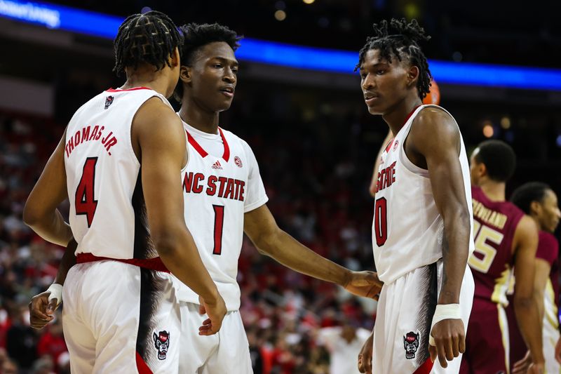 Feb 1, 2023; Raleigh, North Carolina, USA; North Carolina State Wolfpack guard LJ Thomas (4), guard Jarkel Joiner (1), and guard Terquavion Smith (0) huddle during the second half against Florida State Seminoles at PNC Arena.  Mandatory Credit: Jaylynn Nash-USA TODAY Sports