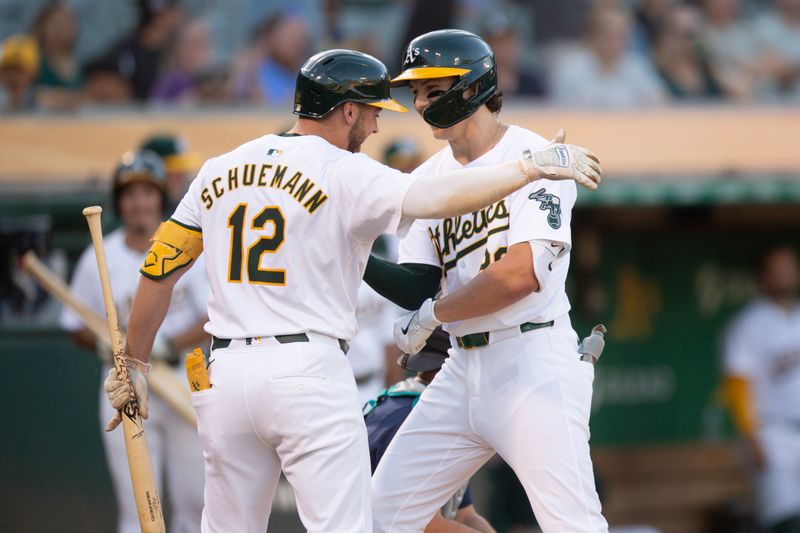 Jun 5, 2024; Oakland, California, USA; Oakland Athletics second baseman Zack Gelof (right) is greeted by teammate Max Schuemann (12) after hitting a solo home run against the Seattle Mariners during the third inning at Oakland-Alameda County Coliseum. Mandatory Credit: D. Ross Cameron-USA TODAY Sports