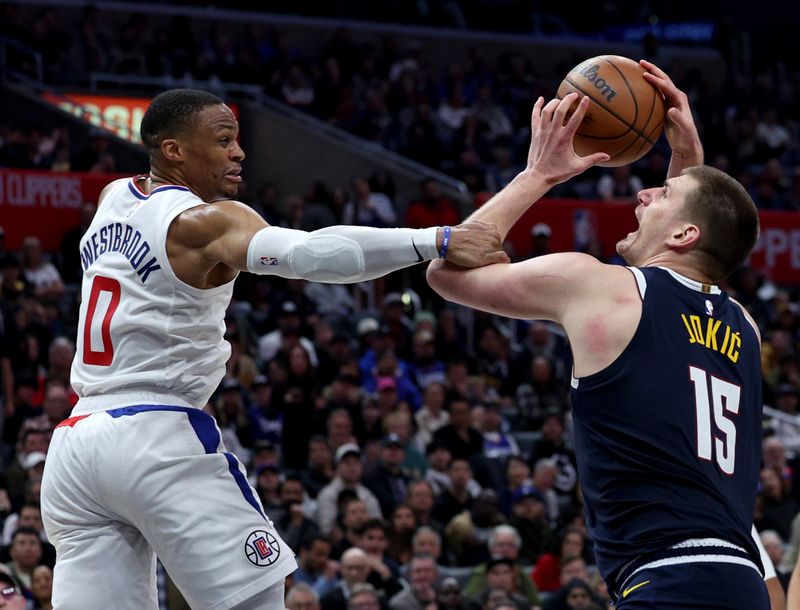 LOS ANGELES, CALIFORNIA - APRIL 04: Nikola Jokic #15 of the Denver Nuggets reacts as he is fouled by Russell Westbrook #0 of the LA Clippers during a 102-100 Clippers win at Crypto.com Arena on April 04, 2024 in Los Angeles, California. User is consenting to the terms and conditions of the Getty Images License Agreement. (Photo by Harry How/Getty Images)