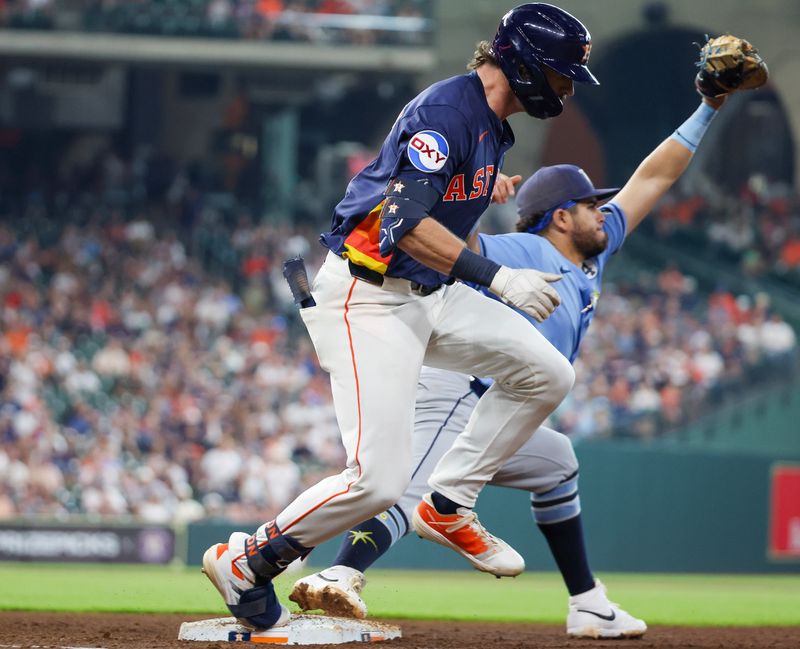 Jun 1, 2025; Houston, Texas, USA;  Houston Astros center fielder Jacob Melton (31) hits a single and beats the throw against the Tampa Bay Rays in the fifth inning at Daikin Park. Mandatory Credit: Thomas Shea-Imagn Images