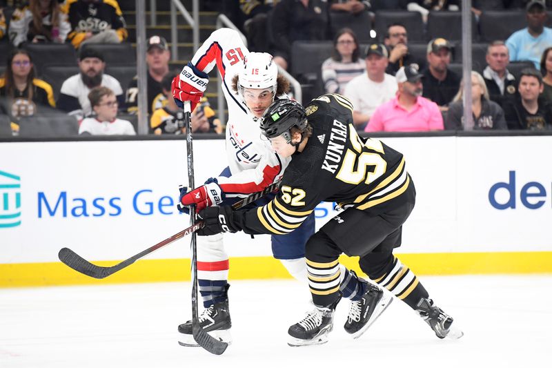 Oct 3, 2023; Boston, Massachusetts, USA;  Washington Capitals left wing Sonny Milano (15) and Boston Bruins left wing Trevor Kuntar (52) battle for position during the first period at TD Garden. Mandatory Credit: Bob DeChiara-USA TODAY Sports