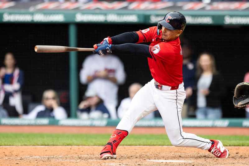 Apr 14, 2024; Cleveland, Ohio, USA; Cleveland Guardians second baseman Andres Gimenez (0) hits a RBI single to win the game against the New York Yankees during the tenth inning at Progressive Field. Mandatory Credit: Scott Galvin-USA TODAY Sports