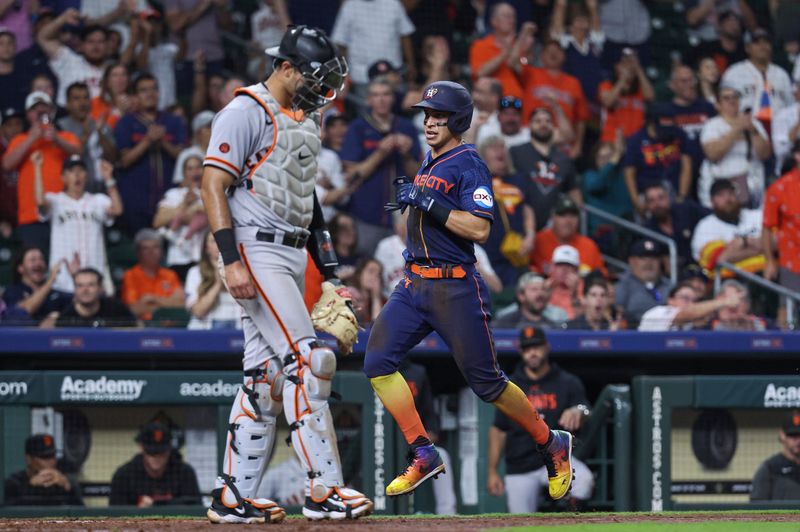 May 1, 2023; Houston, Texas, USA; Houston Astros second baseman Mauricio Dubon (14) scores a run past San Francisco Giants catcher Blake Sabol (2) during the seventh inning at Minute Maid Park. Mandatory Credit: Troy Taormina-USA TODAY Sports