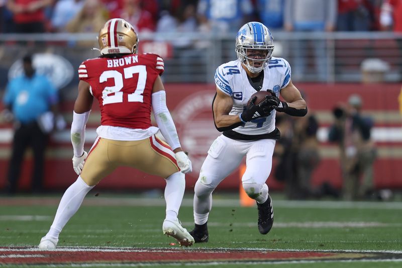 Detroit Lions wide receiver Amon-Ra St. Brown, right, runs against San Francisco 49ers safety Ji'Ayir Brown (27) during the first half of the NFC Championship NFL football game in Santa Clara, Calif., Sunday, Jan. 28, 2024. (AP Photo/Jed Jacobsohn)