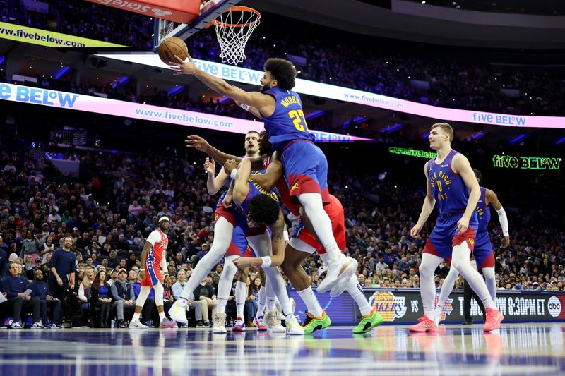 PHILADELPHIA, PENNSYLVANIA - JANUARY 31: Jamal Murray #27 of the Denver Nuggets reaches for the ball against Guerschon Yabusele #28 of the Philadelphia 76ers during the first half at the Wells Fargo Center on January 31, 2025 in Philadelphia, Pennsylvania. NOTE TO USER: User expressly acknowledges and agrees that, by downloading and or using this photograph, User is consenting to the terms and conditions of the Getty Images License Agreement. (Photo by Emilee Chinn/Getty Images)