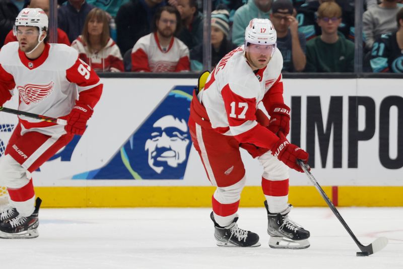 Feb 19, 2024; Seattle, Washington, USA; Detroit Red Wings right wing Daniel Sprong (17) skates with the puck against the Seattle Kraken during the first period at Climate Pledge Arena. Mandatory Credit: Joe Nicholson-USA TODAY Sports