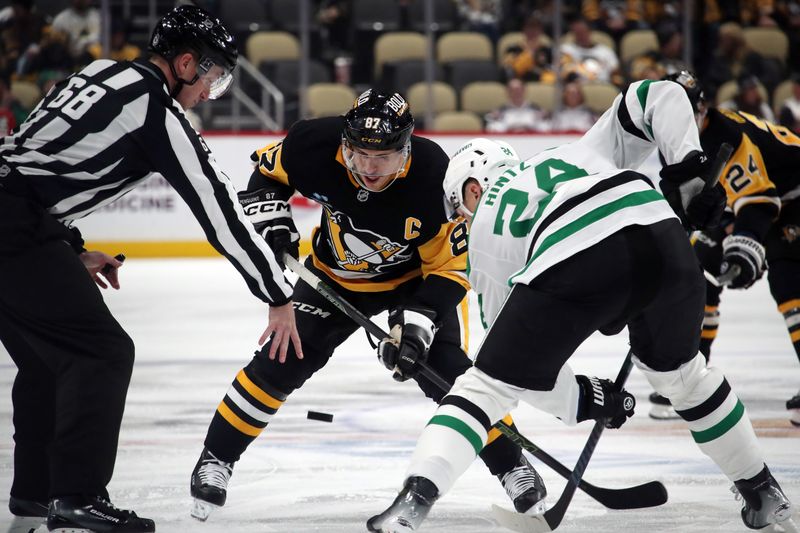 Nov 11, 2024; Pittsburgh, Pennsylvania, USA;  Pittsburgh Penguins center Sidney Crosby (87) and Dallas Stars center Roope Hintz (24) take a face-off during the third period at PPG Paints Arena. Mandatory Credit: Charles LeClaire-Imagn Images