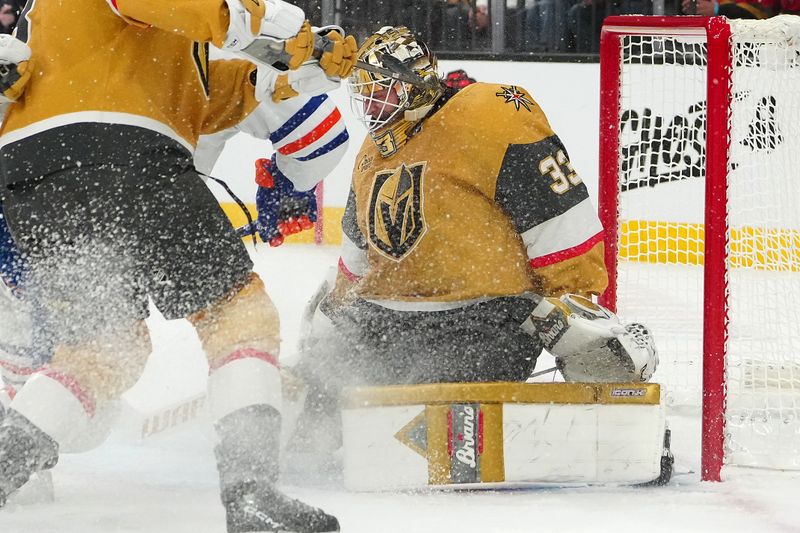 Dec 3, 2024; Las Vegas, Nevada, USA; Vegas Golden Knights goaltender Adin Hill (33) defends his net against the Edmonton Oilers during the first period at T-Mobile Arena. Mandatory Credit: Stephen R. Sylvanie-Imagn Images