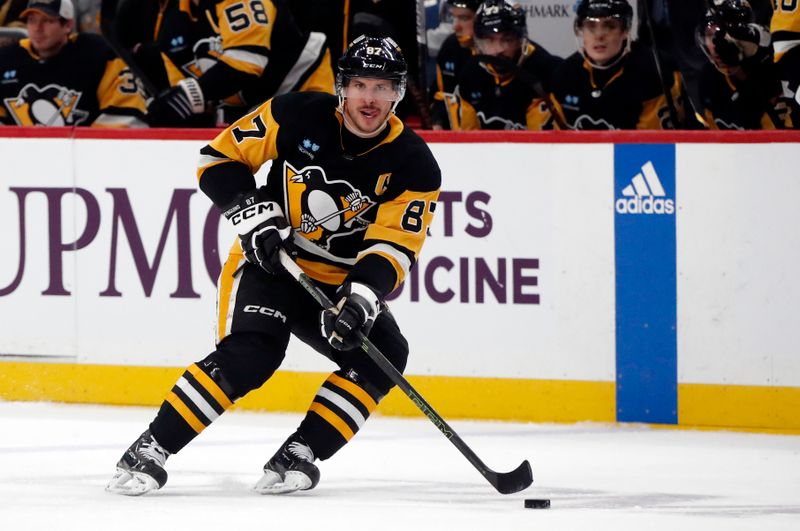 Mar 26, 2024; Pittsburgh, Pennsylvania, USA; Pittsburgh Penguins center Sidney Crosby (87) skates up ice with the puck against  the Carolina Hurricanes at PPG Paints Arena. Mandatory Credit: Charles LeClaire-USA TODAY Sports