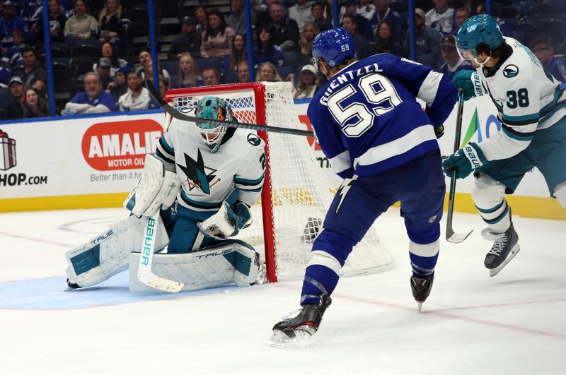 Dec 5, 2024; Tampa, Florida, USA; San Jose Sharks goaltender Mackenzie Blackwood (29) makes a save from Tampa Bay Lightning center Jake Guentzel (59) during the third period at Amalie Arena. Mandatory Credit: Kim Klement Neitzel-Imagn Images