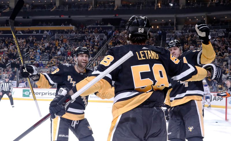 Feb 23, 2023; Pittsburgh, Pennsylvania, USA; Pittsburgh Penguins left wing Jason Zucker (16) and center Evgeni Malkin (71) congratulate defenseman Kris Letang (58) on his goal against the Edmonton Oilers during the first period at PPG Paints Arena. Mandatory Credit: Charles LeClaire-USA TODAY Sports