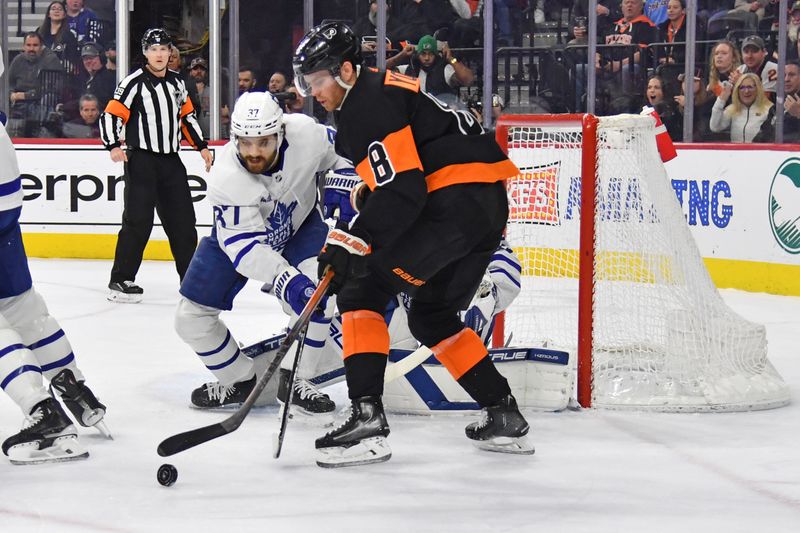 Mar 19, 2024; Philadelphia, Pennsylvania, USA; Toronto Maple Leafs defenseman Timothy Liljegren (37) and Philadelphia Flyers defenseman Cam York (8) battle for the puck during the first period at Wells Fargo Center. Mandatory Credit: Eric Hartline-USA TODAY Sports