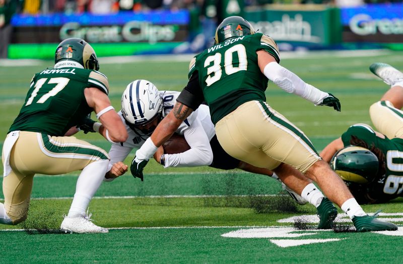 Nov 18, 2023; Fort Collins, Colorado, USA;  Nevada Wolf Pack quarterback AJ Bianco (10) dives for a few extra yards against Colorado State Rams defensive back Jack Howell (17) nd Colorado State Rams linebacker Chase Wilson (30) at Sonny Lubick Field at Canvas Stadium. Mandatory Credit: Michael Madrid-USA TODAY Sports