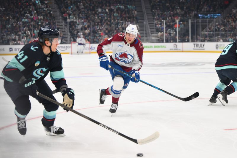 Dec 16, 2025; Seattle, Washington, USA; Colorado Avalanche center Jack Drury (18) defends Seattle Kraken defenseman Ryker Evans (41) during the first period at Climate Pledge Arena. Mandatory Credit: Steven Bisig-Imagn Images