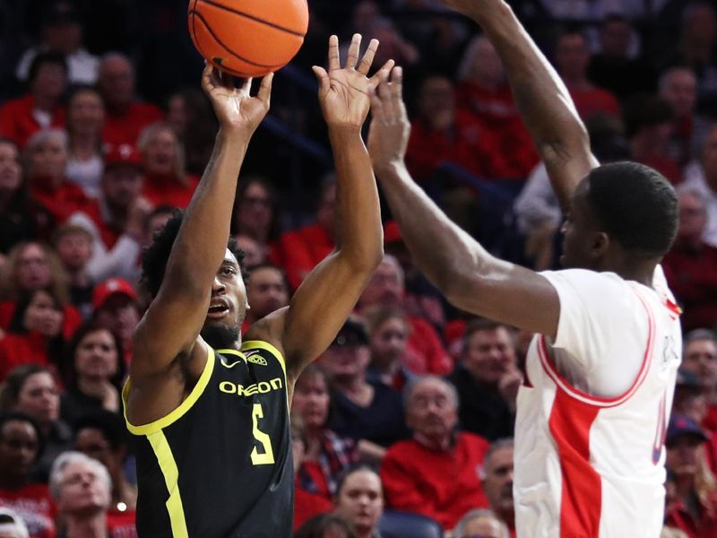 Feb 2, 2023; Tucson, Arizona, USA; Oregon Ducks guard Jermaine Couisnard (5) makes a basket against Arizona Wildcats guard Courtney Ramey (0) in the first half at McKale Center. Mandatory Credit: Zachary BonDurant-USA TODAY Sports