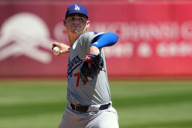 Aug 4, 2024; Oakland, California, USA; Los Angeles Dodgers starting pitcher River Ryan (77) throws a pitch against the Oakland Athletics during the fourth inning at Oakland-Alameda County Coliseum. Mandatory Credit: Darren Yamashita-USA TODAY Sports