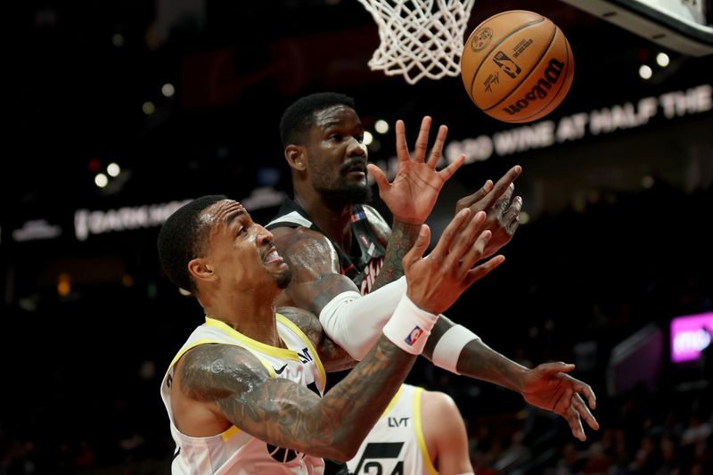 PORTLAND, OREGON - DECEMBER 06: John Collins #20 of the Utah Jazz and Deandre Ayton #2 of the Portland Trail Blazers reach for a rebound during the second half at Moda Center on December 06, 2024 in Portland, Oregon. NOTE TO USER: User expressly acknowledges and agrees that, by downloading and or using this photograph, User is consenting to the terms and conditions of the Getty Images License Agreement. (Photo by Steph Chambers/Getty Images)