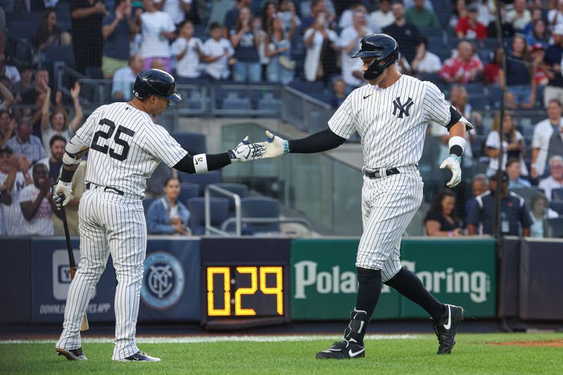 Aug 23, 2023; Bronx, New York, USA; New York Yankees right fielder Aaron Judge (99) celebrates with second baseman Gleyber Torres (25) after his solo home run during the first inning against the Washington Nationals at Yankee Stadium. Mandatory Credit: Vincent Carchietta-USA TODAY Sports