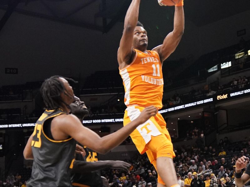 Feb 20, 2024; Columbia, Missouri, USA; Tennessee Volunteers forward Tobe Awaka (11) dunks the ball as Missouri Tigers center Mabor Majak (45) looks on during the second half at Mizzou Arena. Mandatory Credit: Denny Medley-USA TODAY Sports