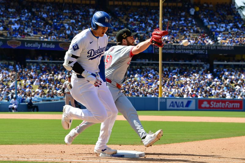 May 19, 2024; Los Angeles, California, USA; Los Angeles Dodgers designated hitter Shohei Ohtani (17) reaches first ahead of Cincinnati Reds pitcher Sam Moll (50) during the eighth inning at Dodger Stadium. Mandatory Credit: Gary A. Vasquez-USA TODAY Sports